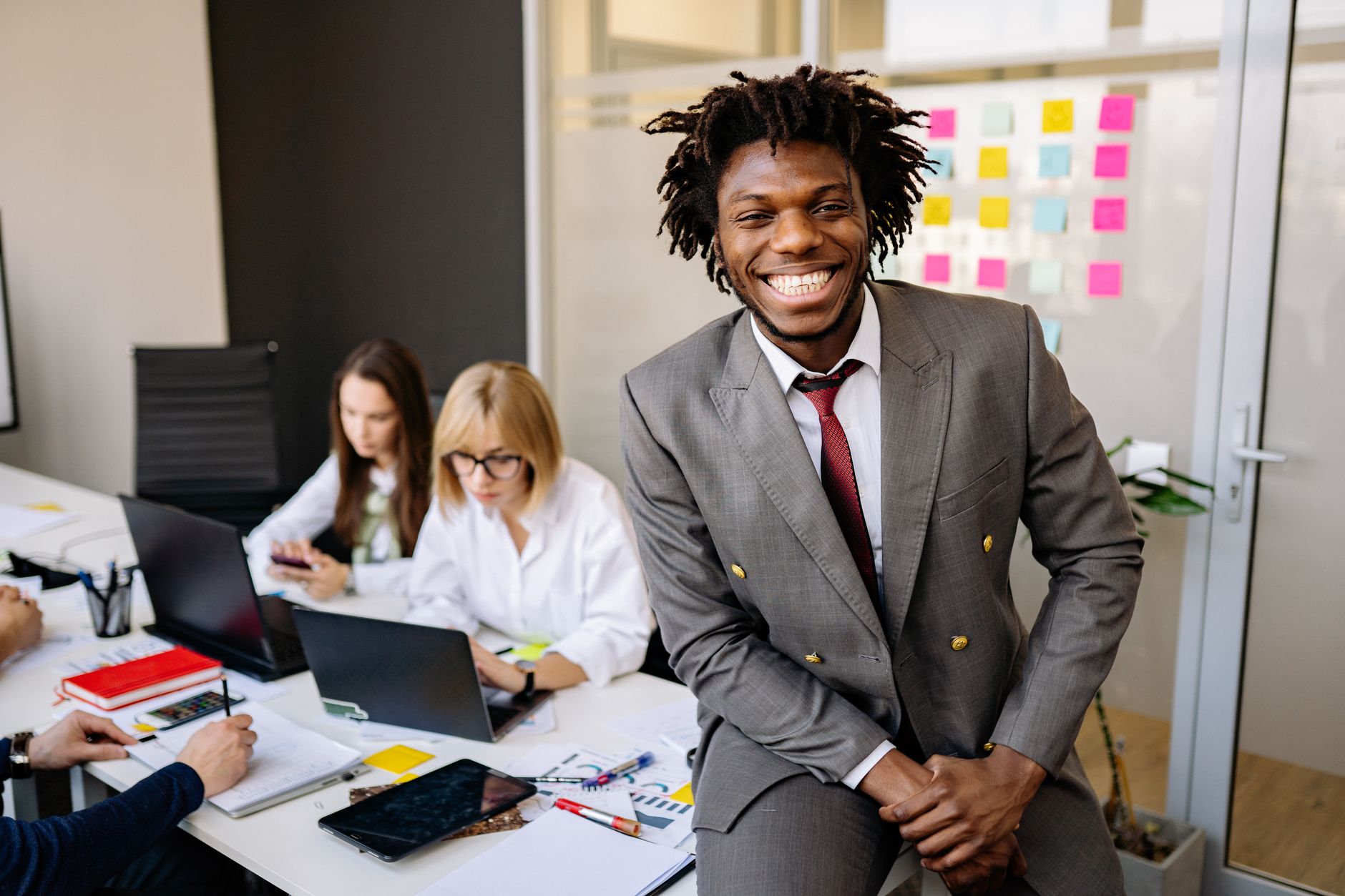 Happy colleagues working together in a modern office setting, showcasing diversity